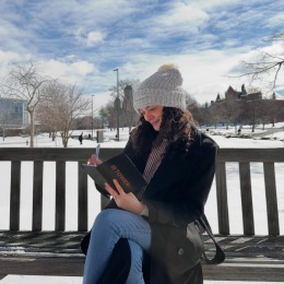 Taking notes on where to live this fall? Here’s a hint: Tower 701!  Don’t miss your chance to secure a spot in one of Syracuse’s newest housing communities. Lock in your future home at Tower701.com a person with a notebook sitting on a bench outside